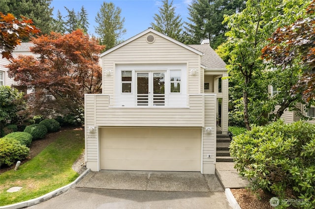11211 NE 106th Pl, Kirkland, WA 98033 - view of front of house with an attached garage, driveway, and roof with shingles