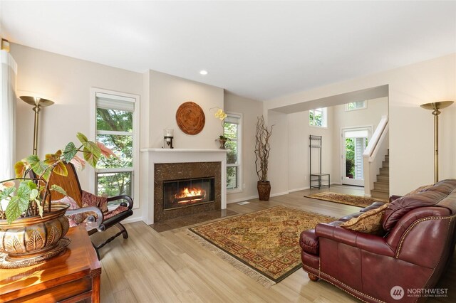 11211 NE 106th Pl, Kirkland, WA 98033 - living area with wood finished floors, a high end fireplace, recessed lighting, and stairs