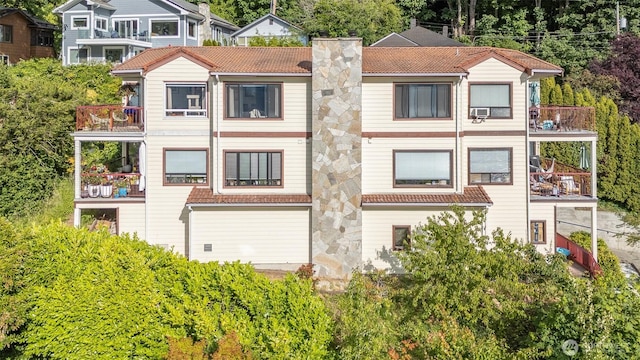 5310 SW College St, Seattle, WA 98116 - rear view of house with a balcony, a chimney, and a tile roof