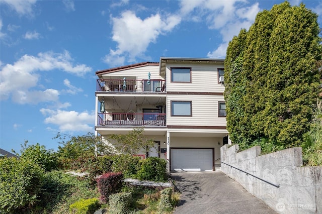 5310 SW College St, Seattle, WA 98116 - view of front of home featuring a balcony, asphalt driveway, and a garage