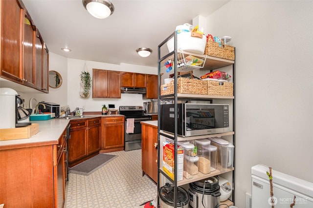 5310 SW College St, Seattle, WA 98116 - kitchen with appliances with stainless steel finishes, under cabinet range hood, and light countertops