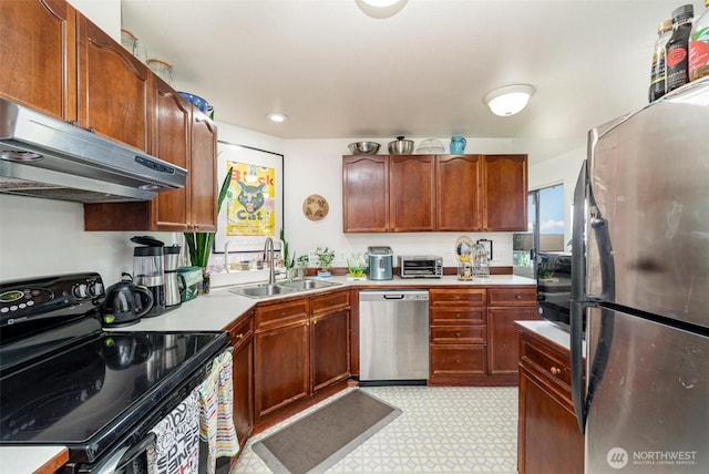 5310 SW College St, Seattle, WA 98116 - kitchen with appliances with stainless steel finishes, range hood, light countertops, light floors, and recessed lighting