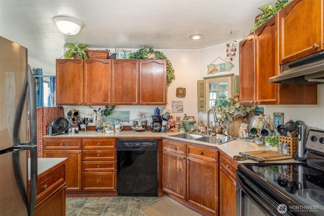 5310 SW College St, Seattle, WA 98116 - kitchen featuring appliances with stainless steel finishes, under cabinet range hood, light countertops, dark stone finish flooring, and brown cabinets