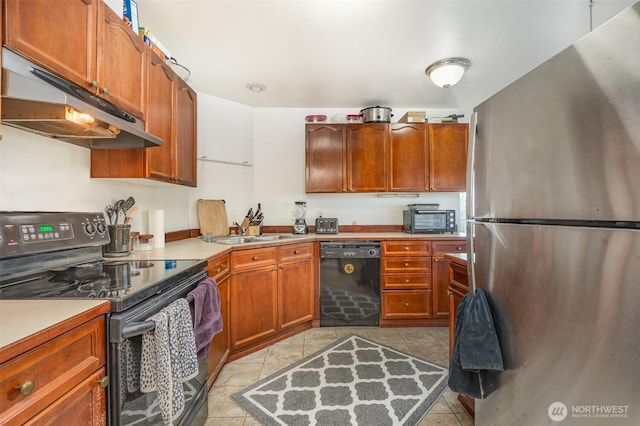 5310 SW College St, Seattle, WA 98116 - kitchen featuring freestanding refrigerator, electric range oven, black dishwasher, under cabinet range hood, and light tile patterned floors