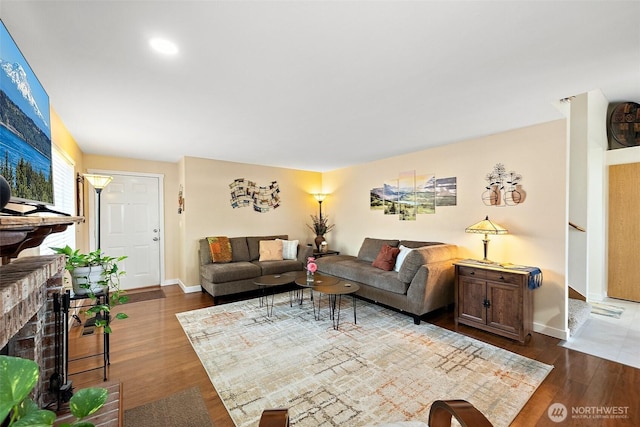 11008 36th Avenue Ct E, Tacoma, WA 98446 - living room with dark wood-style floors and a brick fireplace