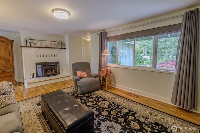 3024 Carpenter Loop SE, Olympia, WA 98503 - living room featuring wood finished floors and a fireplace with raised hearth