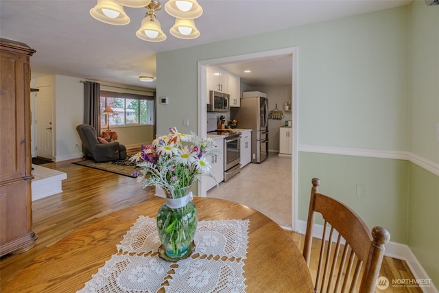 3024 Carpenter Loop SE, Olympia, WA 98503 - dining area featuring a chandelier and light wood-type flooring