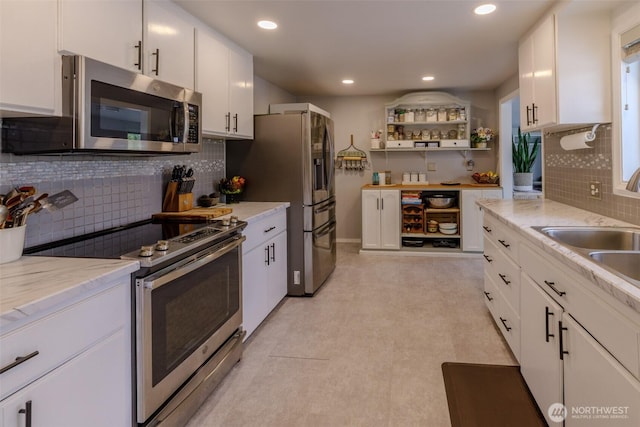3024 Carpenter Loop SE, Olympia, WA 98503 - kitchen with appliances with stainless steel finishes, tasteful backsplash, white cabinets, and recessed lighting