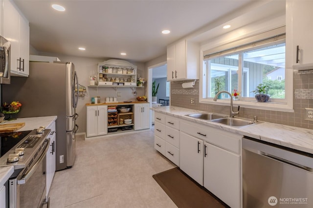 3024 Carpenter Loop SE, Olympia, WA 98503 - kitchen featuring appliances with stainless steel finishes, white cabinetry, tasteful backsplash, recessed lighting, and light stone countertops