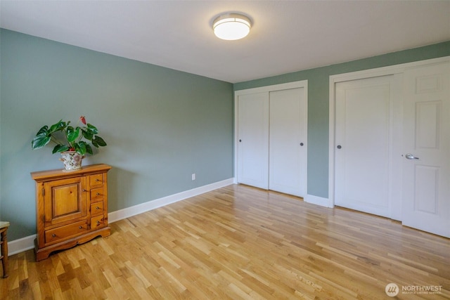 3024 Carpenter Loop SE, Olympia, WA 98503 - unfurnished bedroom with multiple closets and light wood-type flooring