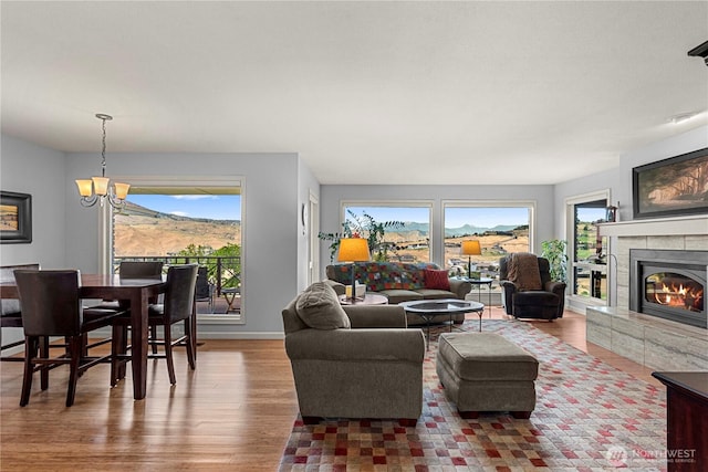 3822 School St, Wenatchee, WA 98801 - living room with a glass covered fireplace, a chandelier, and wood finished floors