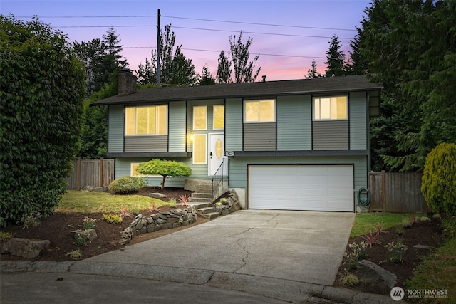 13402 60th Dr SE, Everett, WA 98208 - bi-level home with driveway, a garage, and a chimney