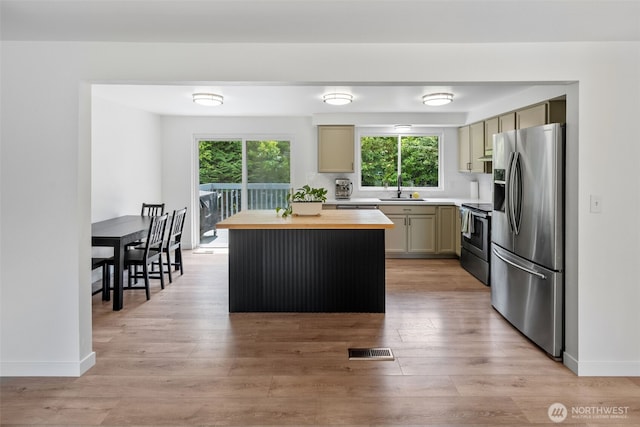 13402 60th Dr SE, Everett, WA 98208 - kitchen featuring stainless steel appliances, butcher block countertops, plenty of natural light, and a center island