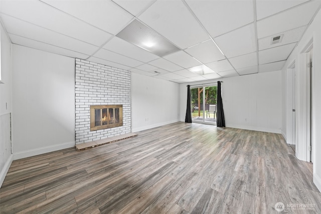 13402 60th Dr SE, Everett, WA 98208 - unfurnished living room featuring wood finished floors, a brick fireplace, and a paneled ceiling