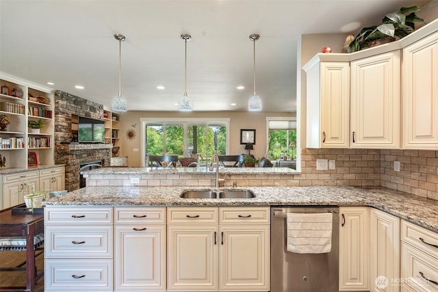 2322 Rice Rd, Chehalis, WA 98532 - kitchen with stainless steel dishwasher, a fireplace, decorative light fixtures, and light stone countertops