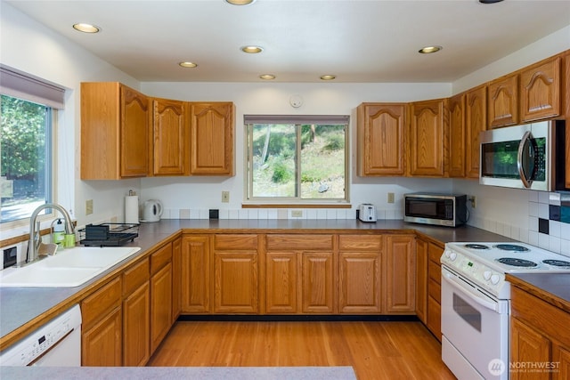227 Bromley Dr, Orcas Island, WA 98245 - kitchen with white appliances, brown cabinets, light wood-style flooring, and recessed lighting