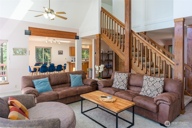 227 Bromley Dr, Orcas Island, WA 98245 - living area with stairs, a ceiling fan, high vaulted ceiling, and light colored carpet