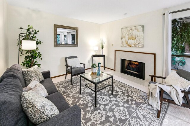 1130 5th Ave S Unit 103, Edmonds, WA 98020 - living area featuring a fireplace with flush hearth and baseboards