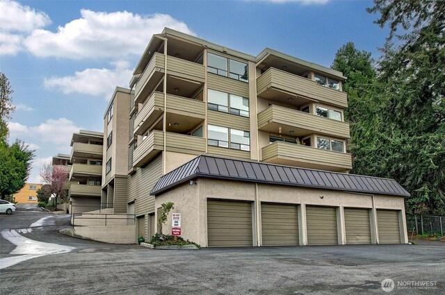 1130 5th Ave S Unit 103, Edmonds, WA 98020 - view of apartment building / complex featuring community garages