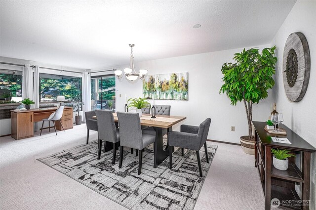 1130 5th Ave S Unit 103, Edmonds, WA 98020 - dining area with light colored carpet, a chandelier, and a textured ceiling