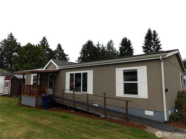 24919 Hoehn Rd Unit 65, Sedro Woolley, WA 98284 - rear view of property featuring crawl space, a lawn, a shed, and a porch
