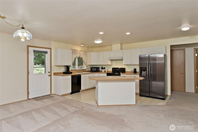 9927 140th St Ct E, Puyallup, WA 98373 - kitchen featuring black appliances, white cabinets, light countertops, and light colored carpet