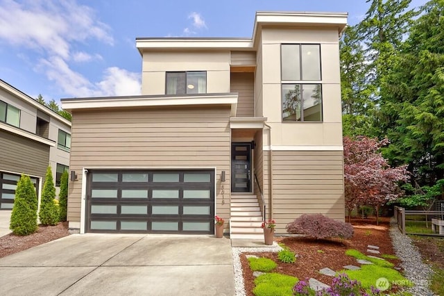 8015 NE 116th Pl, Kirkland, WA 98034 - contemporary house with driveway, a garage, and stucco siding