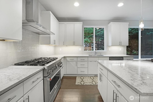 8015 NE 116th Pl, Kirkland, WA 98034 - kitchen featuring wall chimney exhaust hood, stainless steel stove, light stone counters, decorative backsplash, and white cabinetry