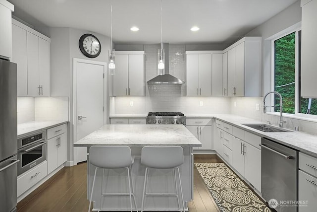 8015 NE 116th Pl, Kirkland, WA 98034 - kitchen with appliances with stainless steel finishes, wall chimney exhaust hood, recessed lighting, decorative backsplash, and light stone counters
