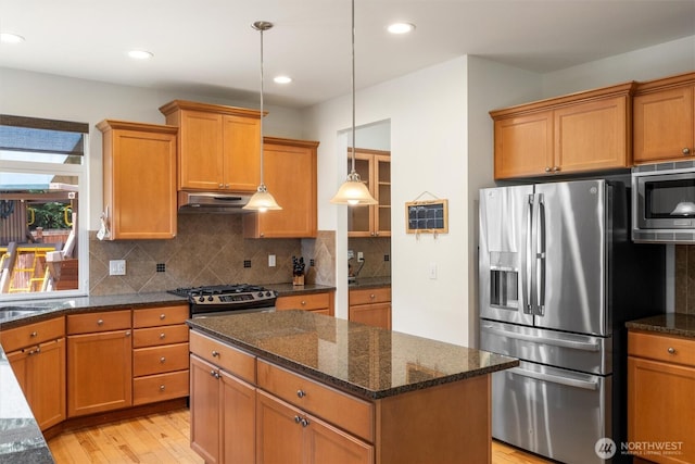 416 199th Pl SE, Bothell, WA 98012 - kitchen featuring appliances with stainless steel finishes, light wood-style floors, a center island, under cabinet range hood, and decorative backsplash