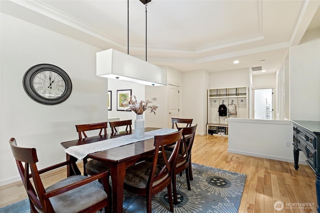 416 199th Pl SE, Bothell, WA 98012 - dining area with crown molding, a raised ceiling, light wood-style floors, and recessed lighting
