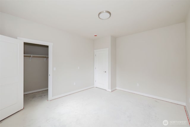 300 E Wild Grape Way, Grapeview, WA 98546 - unfurnished bedroom featuring concrete flooring, a closet, and a spacious closet