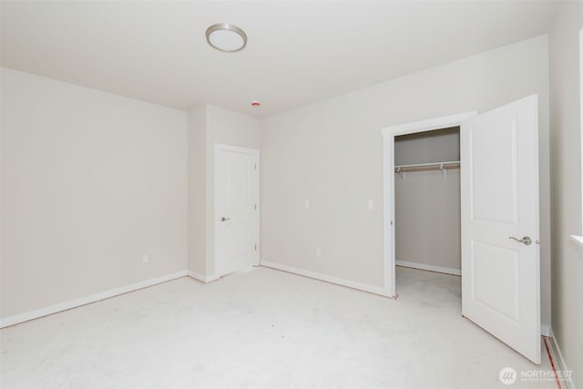 300 E Wild Grape Way, Grapeview, WA 98546 - unfurnished bedroom with light colored carpet, a closet, and a walk in closet