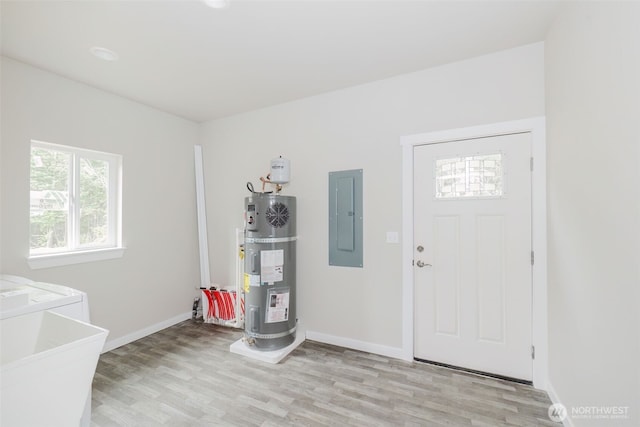 300 E Wild Grape Way, Grapeview, WA 98546 - entryway featuring electric panel, strapped water heater, light wood-style flooring, and washer / clothes dryer