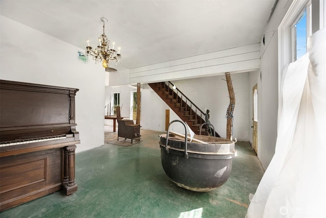 3634 Campbell St NE, Bainbridge Island, WA 98110 - sitting room featuring concrete floors, a chandelier, and stairs