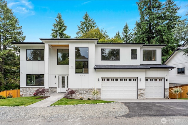 1606 106th Ave SE, Bellevue, WA 98004 - contemporary house with stone siding, a garage, french doors, driveway, and board and batten siding