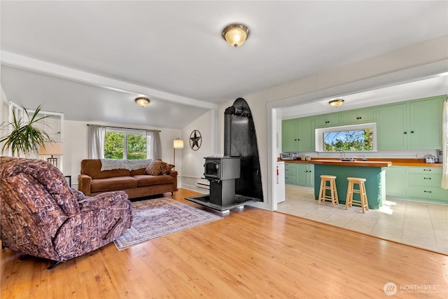 50 Lower Bear Creek Rd, Winthrop, WA 98862 - living area featuring a wood stove, lofted ceiling, and light wood finished floors