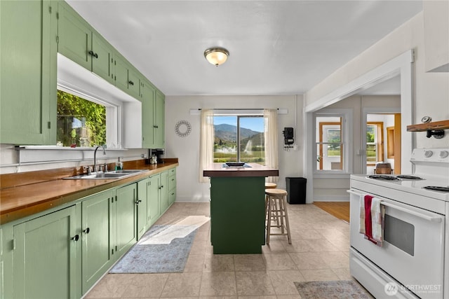 50 Lower Bear Creek Rd, Winthrop, WA 98862 - kitchen with green cabinets, white electric range oven, a breakfast bar area, and light tile patterned flooring