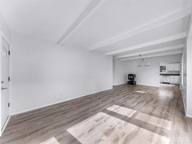 309 Bennett St, Sedro Woolley, WA 98284 - unfurnished living room with beamed ceiling, wood finished floors, and a chandelier