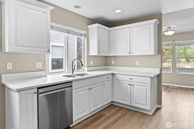 2237 Tolmie St, Dupont, WA 98327 - kitchen with dishwasher, white cabinets, light wood-style floors, light countertops, and recessed lighting