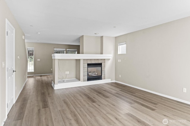 2237 Tolmie St, Dupont, WA 98327 - unfurnished living room with wood finished floors and a fireplace