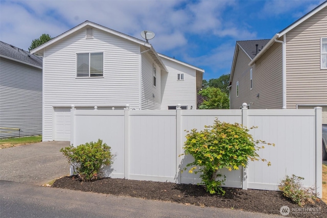 2237 Tolmie St, Dupont, WA 98327 - view of property exterior with driveway and a garage