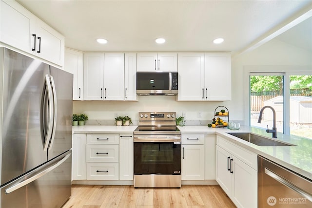 27409 146th Ave SE, Kent, WA 98042 - kitchen with appliances with stainless steel finishes, white cabinetry, light wood-type flooring, and recessed lighting