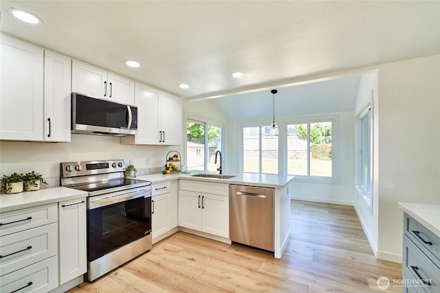 27409 146th Ave SE, Kent, WA 98042 - kitchen featuring stainless steel appliances, a peninsula, light wood-type flooring, light countertops, and white cabinets