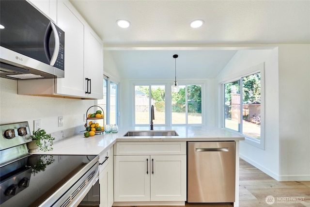 27409 146th Ave SE, Kent, WA 98042 - kitchen with appliances with stainless steel finishes, vaulted ceiling, light wood-style floors, a peninsula, and white cabinetry