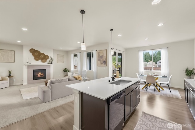 9018 Viola St SE, Tumwater, WA 98501 - kitchen with dishwasher, light countertops, light wood-type flooring, recessed lighting, and a tile fireplace