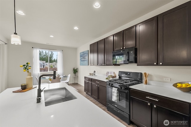 9018 Viola St SE, Tumwater, WA 98501 - kitchen featuring black appliances, light countertops, wood finished floors, dark brown cabinetry, and recessed lighting