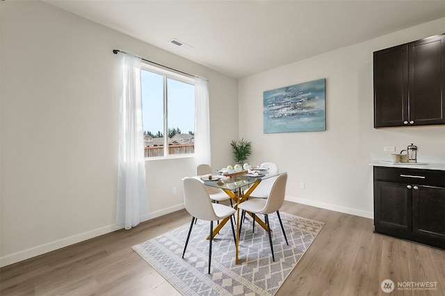 9018 Viola St SE, Tumwater, WA 98501 - dining room featuring light wood-type flooring and baseboards