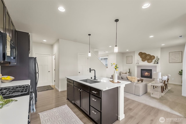 9018 Viola St SE, Tumwater, WA 98501 - kitchen featuring light wood-style flooring, light countertops, open floor plan, recessed lighting, and black microwave