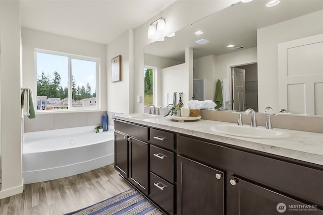 9018 Viola St SE, Tumwater, WA 98501 - full bath featuring double vanity, a bath, wood finished floors, and recessed lighting